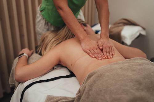 a woman getting a massage from a therapist at Alpen Resort & Spa in Zermatt