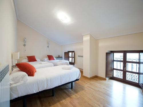 a large bedroom with two beds and a window at Apartamentos Señorio de Haro 3000 in Haro