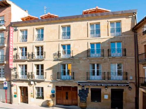 a large building with windows and balconies on a street at Apartamentos Señorio de Haro 3000 in Haro