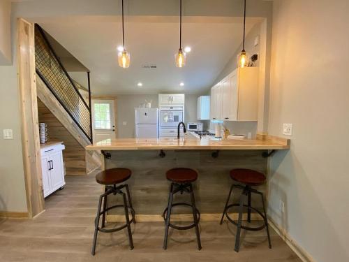 a kitchen with two bar stools at a kitchen island at Southern Utah Hidden Gem Near Zion National Park in Orderville