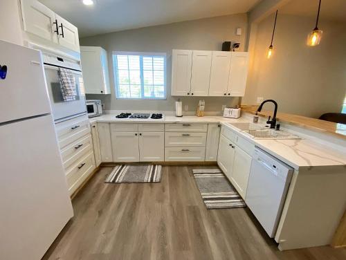 a kitchen with white cabinets and white appliances at Southern Utah Hidden Gem Near Zion National Park in Orderville