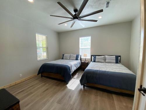 a bedroom with two beds and a ceiling fan at Southern Utah Hidden Gem Near Zion National Park in Orderville