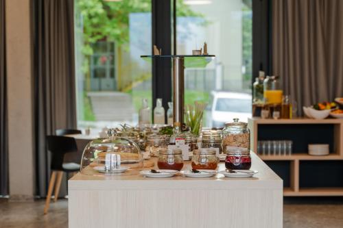 a table with jars and plates of food on it at Hotel Soča in Bovec