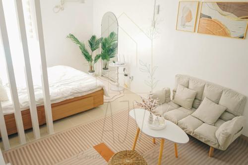 a living room with a couch and a table at AJV Condo Staycation in Manila