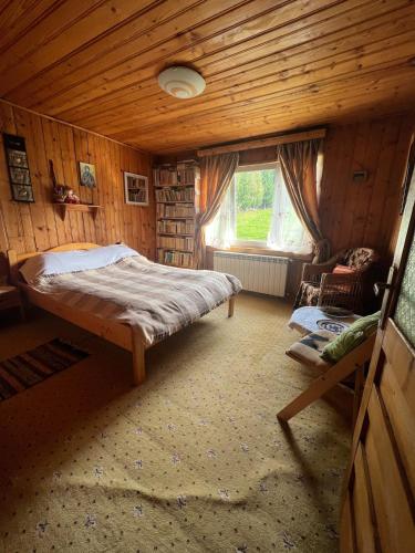 a small bedroom with a bed and a window at Casa Santa Maria Bran in Moieciu de Jos