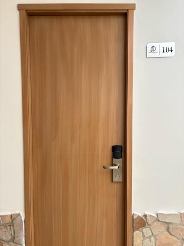 a wooden door with a sign on top of it at Dadison Plaza Hotel in Piedecuesta