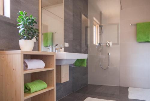 a bathroom with a sink and a shower at Winklerhof Apartments in Brunico