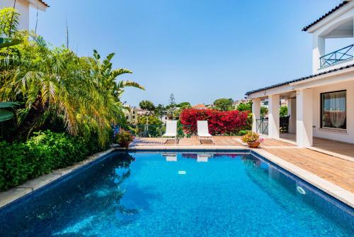 a swimming pool in the backyard of a house at Mbird Estoril Riviera Flat 1 in Estoril