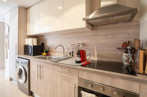 a kitchen with a sink and a stove at Mangroovy Seafront condo - Great Kite Surfing in Hurghada