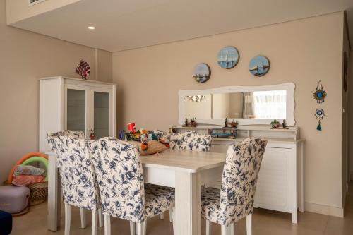 a kitchen with a wooden table and chairs at Mangroovy Seafront condo - Great Kite Surfing in Hurghada