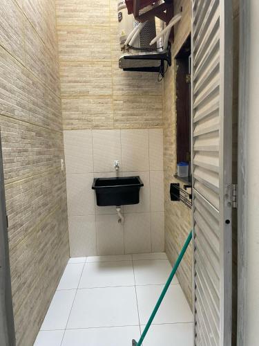 a bathroom with a sink and a toilet at Vila Flor in Cairu