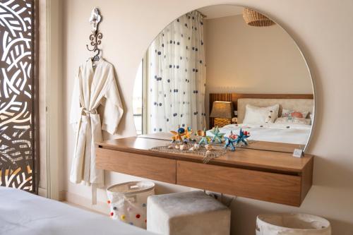 a bedroom with a large mirror and a bed at Mangroovy Seafront condo - Great Kite Surfing in Hurghada