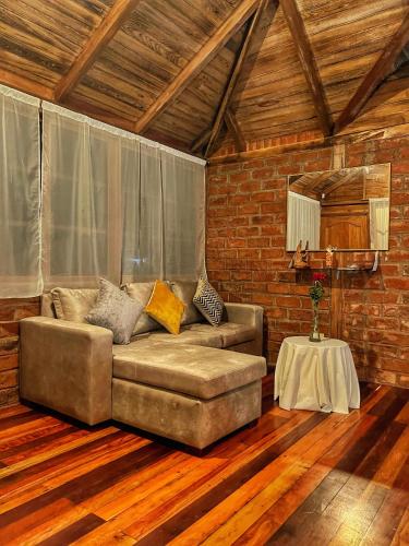 a living room with a couch and a table at Natural Lodge in Madre Tierra
