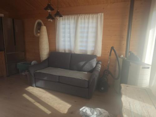 a living room with a couch and a window at Chez Francois in Ardres