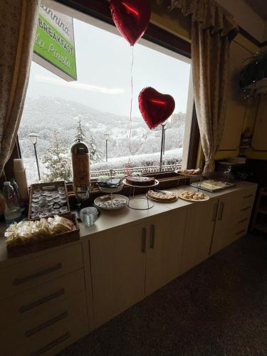 a table with a heart balloon and some food at La Capannina in Roccaraso