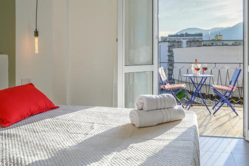 a bedroom with a bed and a balcony with a table at La Cattedrale in La Spezia