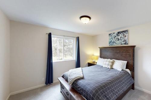 a bedroom with a bed and a window at Lighthouse By The Cove in Seaside