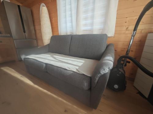 a gray couch in a room with a window at Chez Francois in Ardres