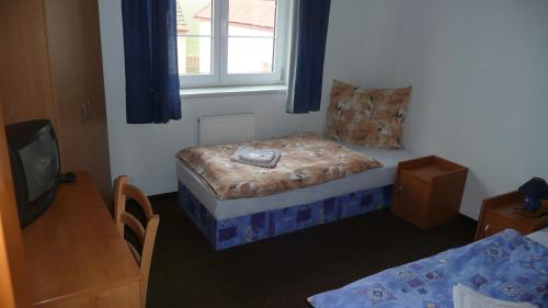 Postel nebo postele na pokoji v ubytování Penzion Hajský mlýn