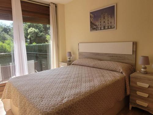 a bedroom with a bed and a large window at PEBA Nudo del Ocho Apartamento en Tina Menor in Pesués