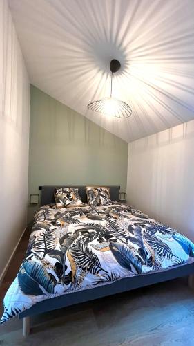 une chambre avec un grand lit avec un plafond dans l'établissement Appartement Clermont-Fd Jaude, à Clermont-Ferrand