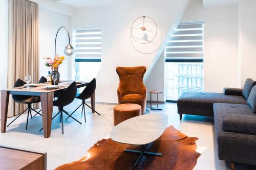 a living room with a table and a couch at Luxury Little Gem Mercury Tower w Rooftop Pool By Arco Collection in St. Julianʼs
