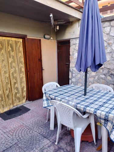 a blue umbrella sitting on a table with chairs at Marconi relax in Filettino Graziani