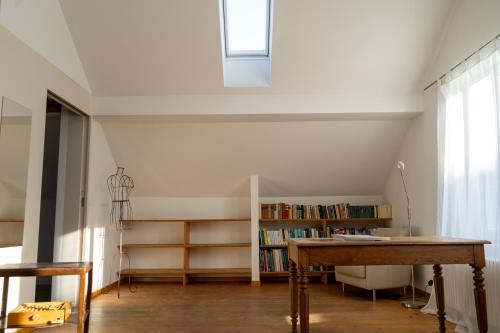 a room with a table and a book shelf at Rheinfall Living in Neuhausen am Rheinfall