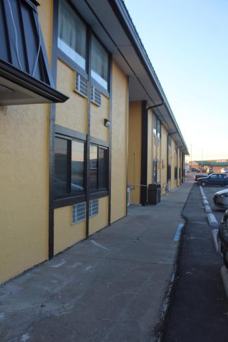 an empty sidewalk next to a yellow building at Extended Stay Warrenton Inn in Warrenton
