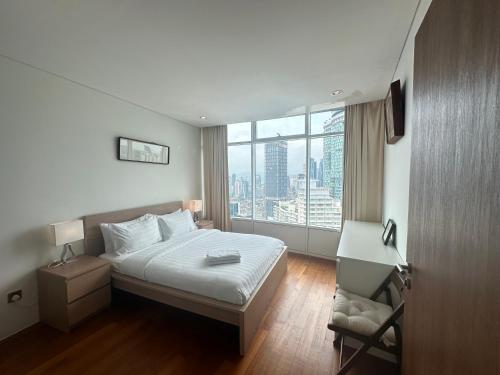 a hotel room with a bed and a window at Vortex Suites KLCC by Angel in Kuala Lumpur