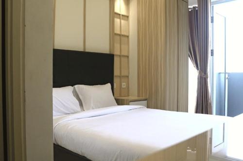 Postel nebo postele na pokoji v ubytování Apartemen cahya view 2