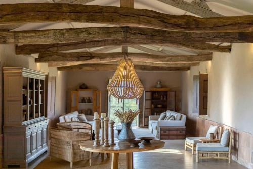 a living room with a table and a chandelier at Terra Rosa Country House & Vineyards in Ponte de Lima