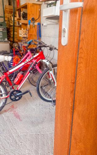two bikes parked next to each other in a garage at Wanda Mtb Paradise Home in Finale Ligure