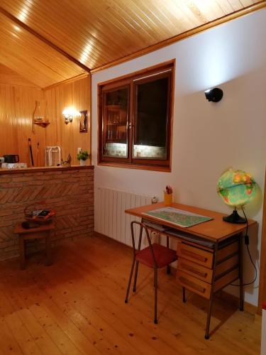a room with a desk and a window and a table at Chalet Nature à 10 minutes d'Etretat in Fongueusemare