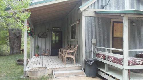a porch of a house with two chairs on it at Quiet Canyon Starry Nights HappyOurs Ranch Bunk Family Home in Glendale