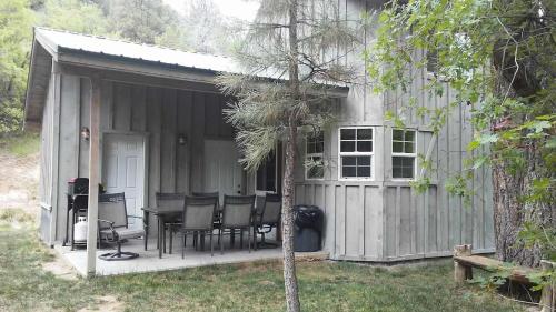 a small shed with a table and chairs in it at Quiet Canyon Starry Nights HappyOurs Ranch Bunk Family Home in Glendale