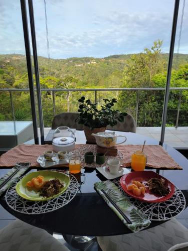 a table with two plates of food and drinks on it at Naturaleza, Flora y Fauna in Los Altos de Cerro Azul