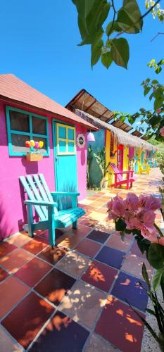 a colorful house with a blue bench on a patio at Dunas Tatacoa in Villavieja