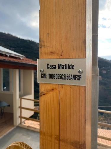 a sign on the side of a wooden house at Casa Matilde in Sanremo