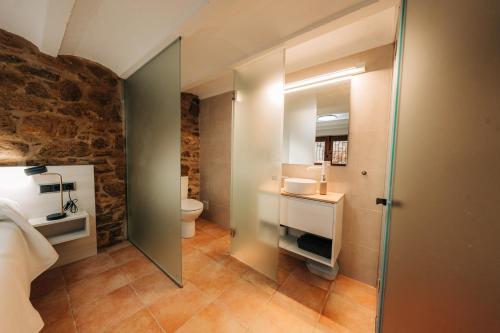 a bathroom with a sink and a toilet in a room at Alojamiento rural la Mola 11 in Benasal