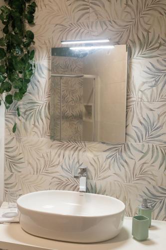 a bathroom with a white sink and a mirror at CasaMilla in Campobasso