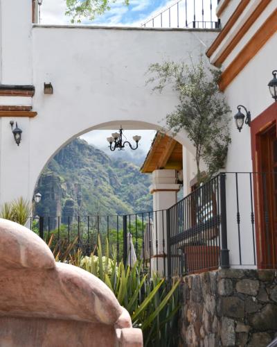 a drone flying over a house with a mountain at Palacio Del Cobre in Tepoztlán