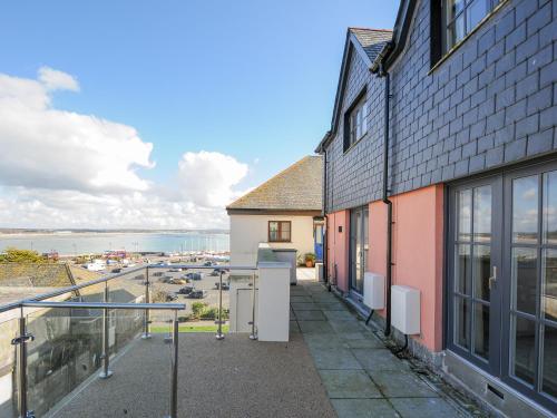 an apartment balcony with a view of the ocean at Wharfside in Penzance