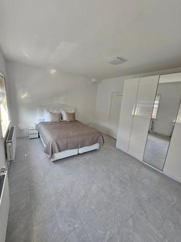 a bedroom with a bed and a tiled floor at Smile Home Wijk aan Zee 1 in Wijk aan Zee