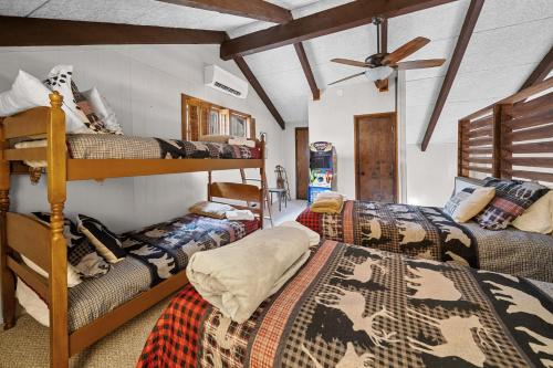 a room with two bunk beds and a fan at Southern Buffalo in Beech Mountain