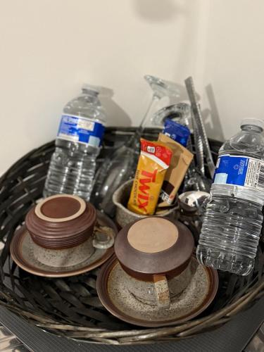 a basket with plates and water bottles on a counter at Gray Bridge House in Kingsthorpe