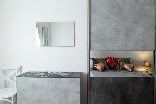 a bedroom with a bunk bed with a mirror at Sweet Home Pioppo in Pioppo