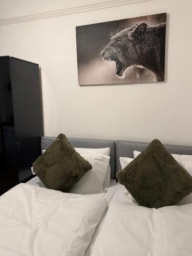a bed with two pillows and a picture of a bear at Gray Bridge House in Kingsthorpe