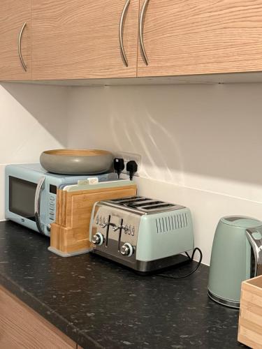a kitchen counter with a toaster and a toaster and a toaster at Gray Bridge House in Kingsthorpe