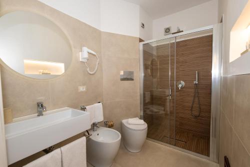 a bathroom with a shower and a toilet and a sink at Cala di Ponente in Castelluzzo